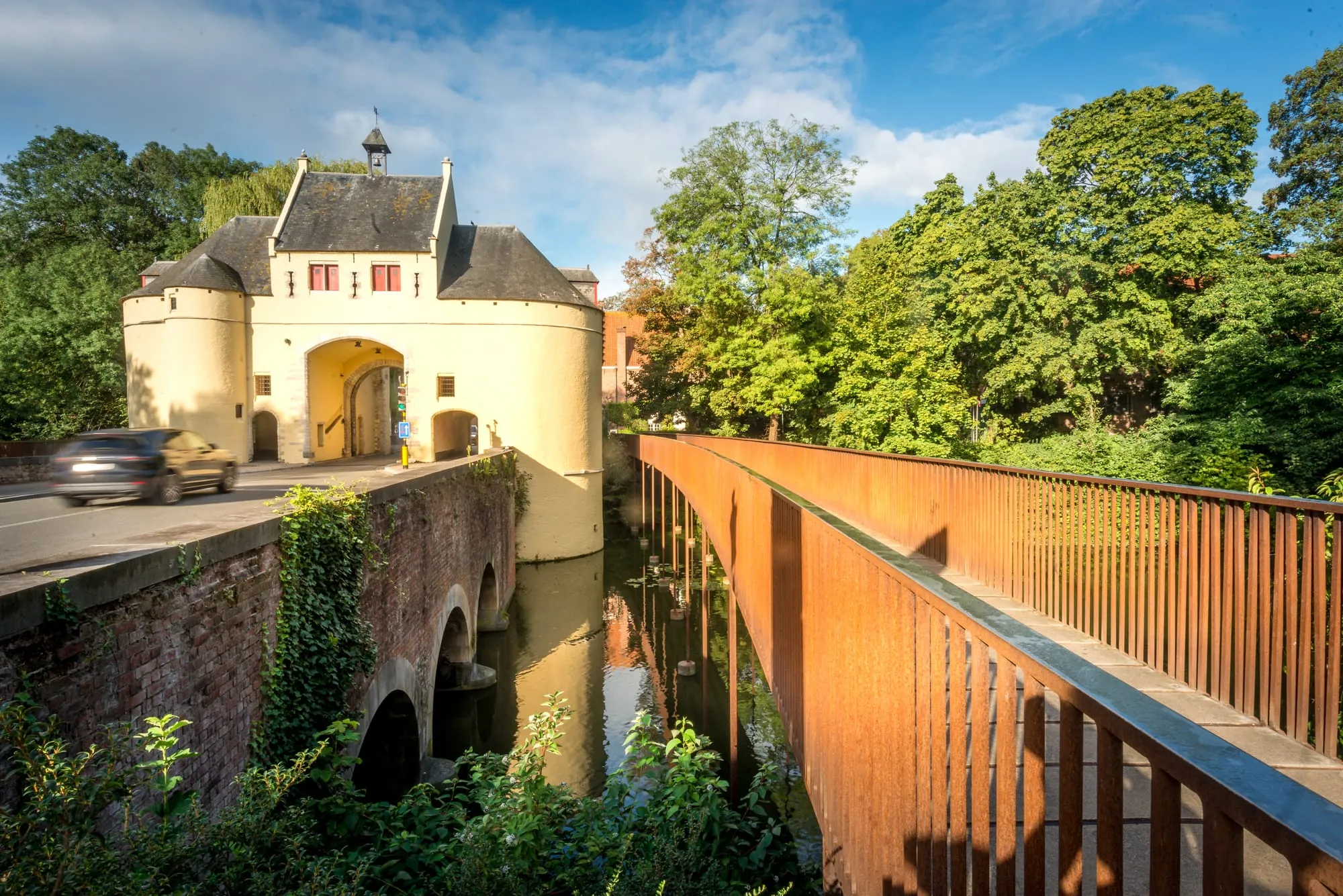 The Smedenpoort city gate and moat seen from a modern footbridge